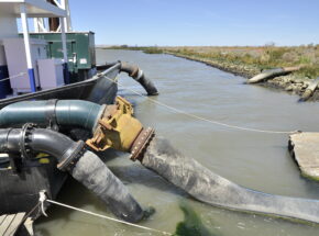 Techniques used to add sediment to the Montezuma Wetlands included hosing it from a sediment laden barge. Photo: Darren Graffuis