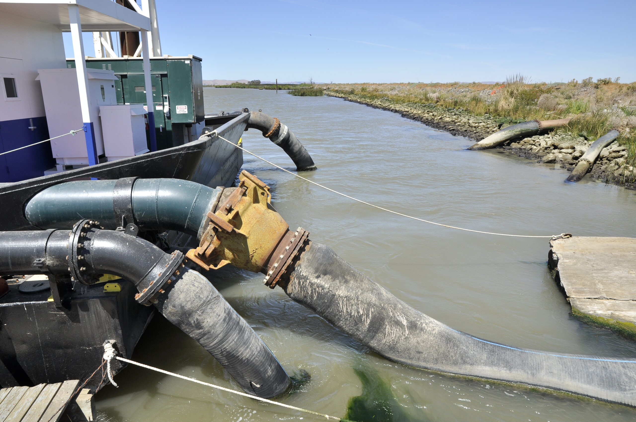 Techniques used to add sediment to the Montezuma Wetlands included hosing it from a sediment laden barge. Photo: Darren Graffuis